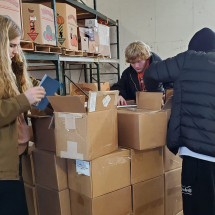 Ryan, Noah, Anthony sorting the boxes donated and the mail items.